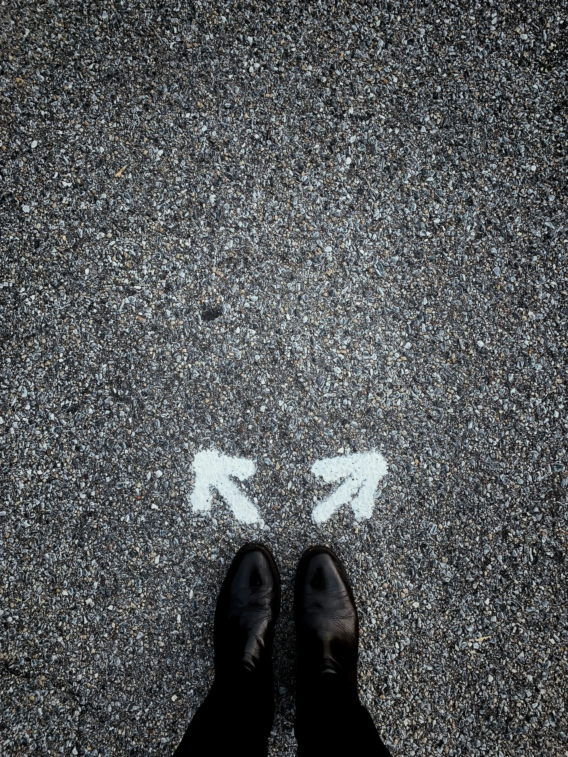 man standing between two directions